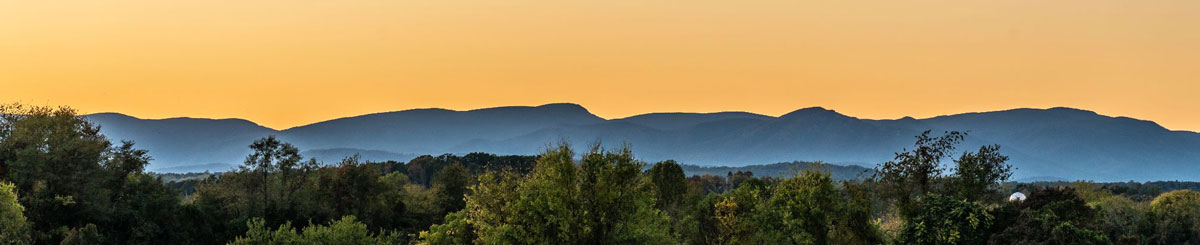 A wide photo of the Blue Ridge Mountains during sunset