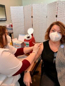 Rose Wallace, marketing director, receives her covid vaccine.