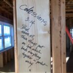 Scripture written on wood framing for walls.