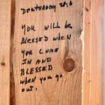 Scripture written on wood framing for walls.